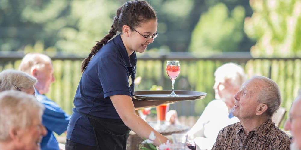 Residents being served at dinning patio at The Springs at Veranda Park in Medford, Oregon