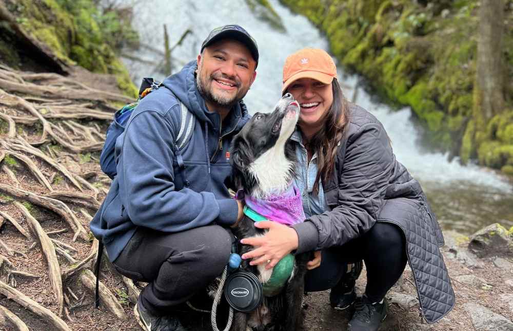 Alison Bouchard, her husband Thomas and dog Ringo by a waterfall