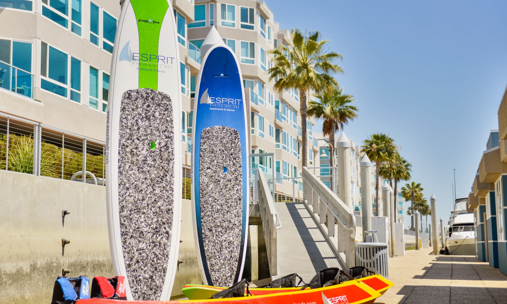 Paddle boards and kayaks sitting outside of Esprit Marina del Rey in Marina del Rey, California