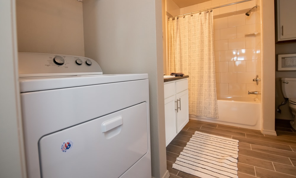Bathroom with laundry at Portico at Friars Creek Apartments in Temple, Texas