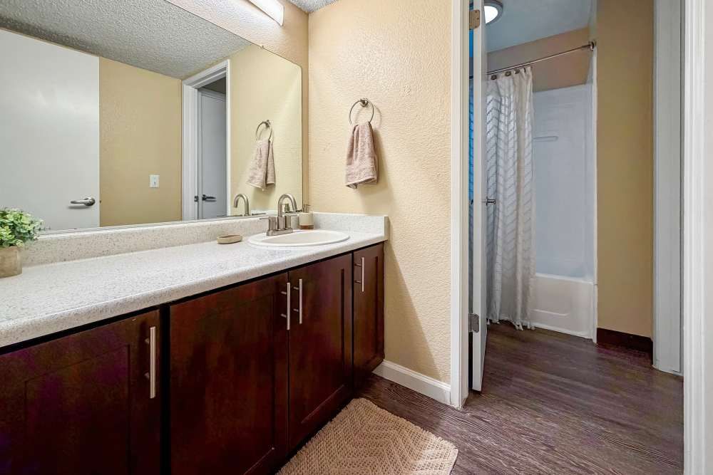 Bathroom with wooden flooring at Bennington Apartments in Fairfield, California