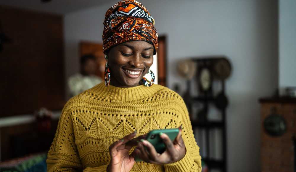 Woman smiling while using her phone at Kirman Garden in Reno, Nevada
