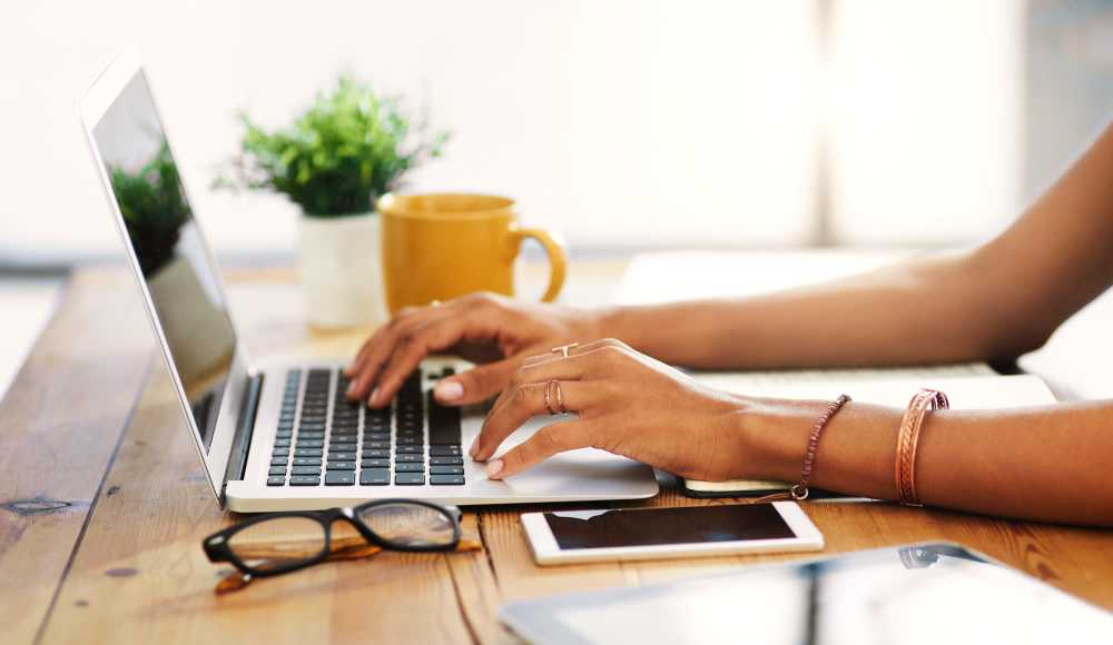 Woman using her laptop at The Rose on Colfax in Denver, Colorado