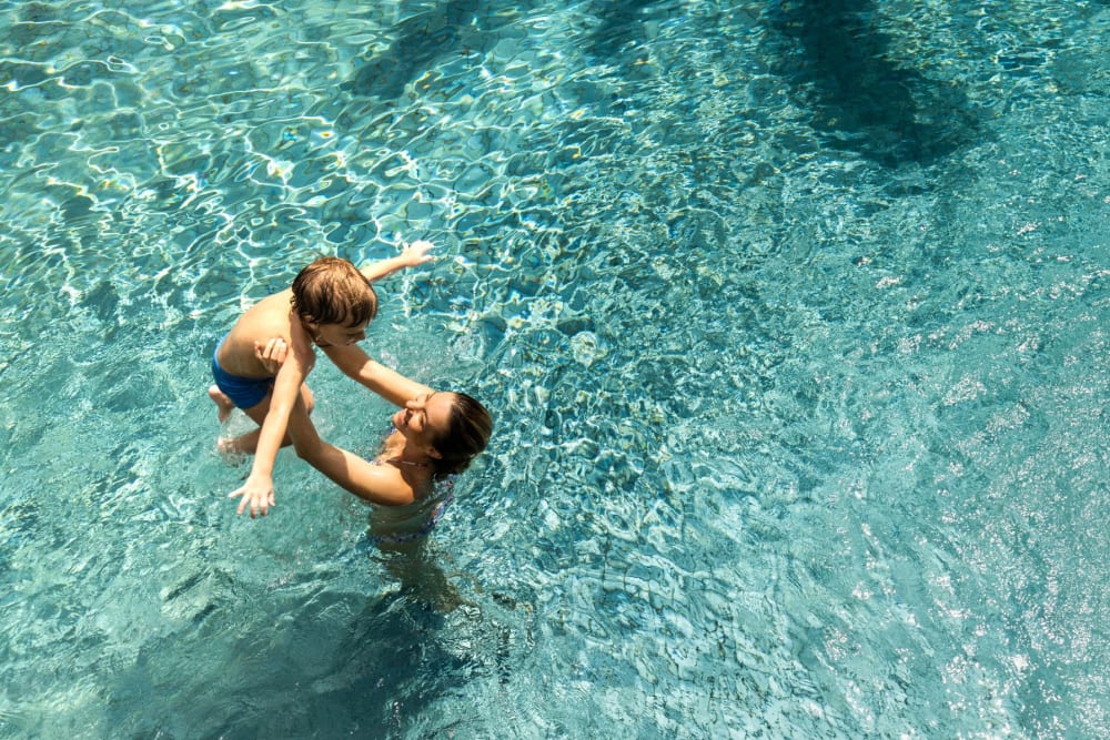 A resident and her child playing in the swimming pool at Enclave at Woodcrest Station in Cherry Hill, New Jersey