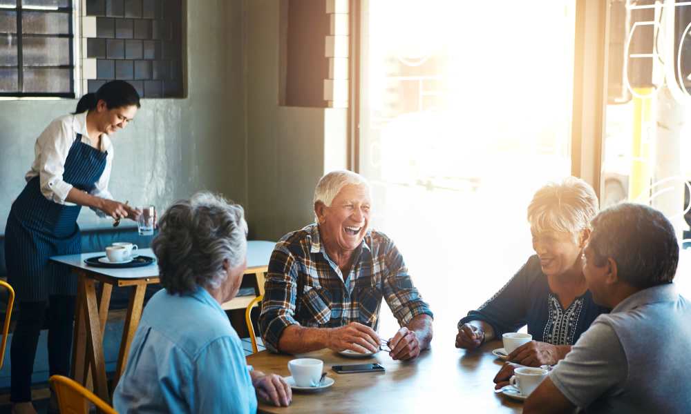 Employees having fun at Heirloom by Ovation in Las Vegas,Nevada discussing among themselves regarding floor plans