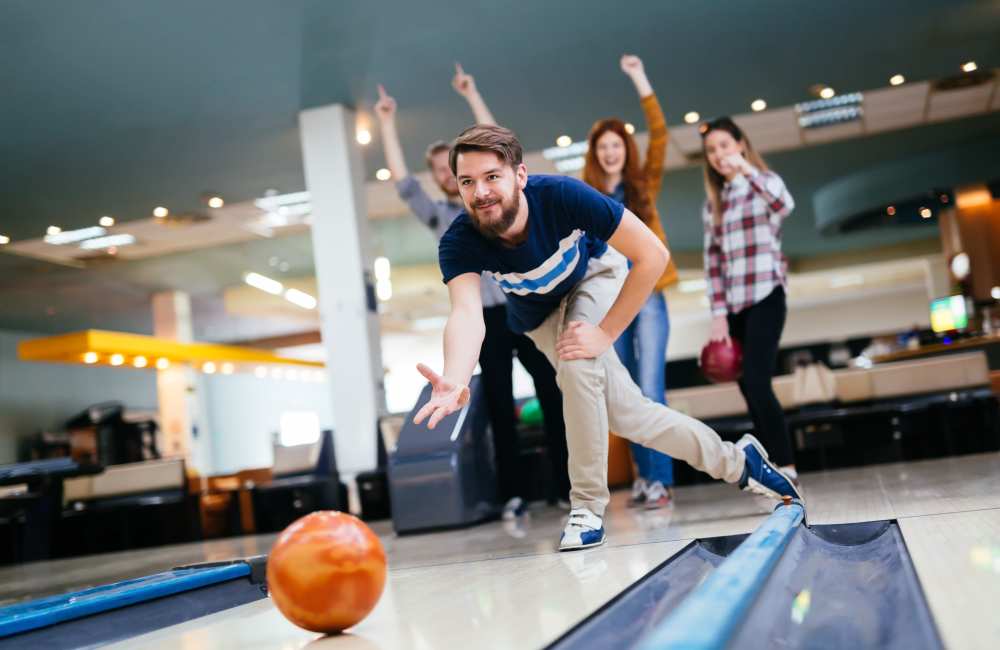 Resident friends playing bowling near Walnut Grove Landing Apartments in Vancouver, Washington