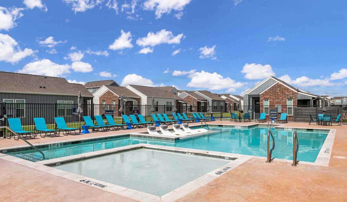 Swimming pool with lounge chairs around pool deck at Elevate at Skyline in McKinney, Texas