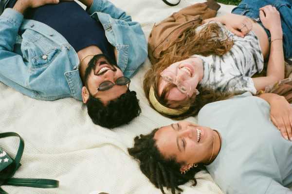 A group of friends sharing laughs in park near  Lexington in The Woodlands, Texas