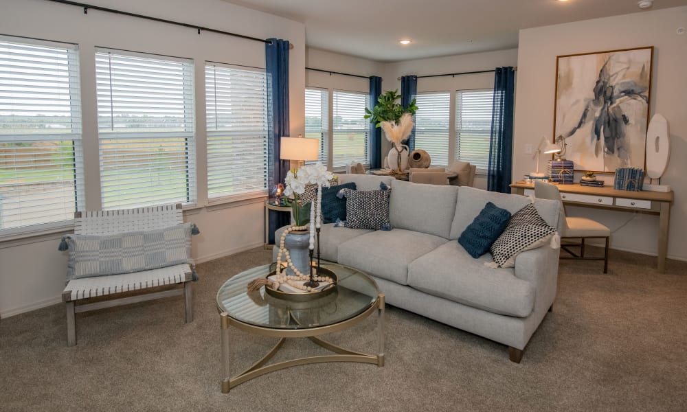 Spacious living room with plush carpeting at Redbud Ranch Apartments in Broken Arrow, Oklahoma