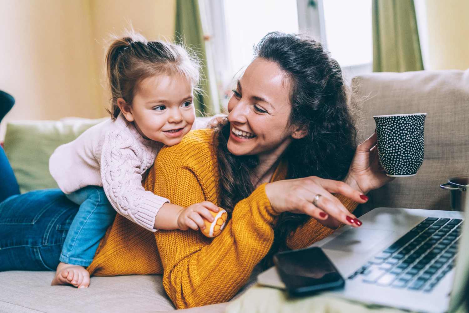 Woman working in her laptop and spending time with her kid at West Elm Villas in Wauseon, Ohio
