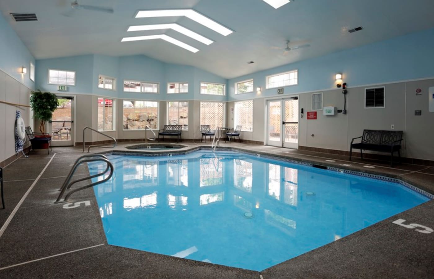Beautiful indoor swimming pool area at Discovery Landing Apartment Homes in Burien, WA