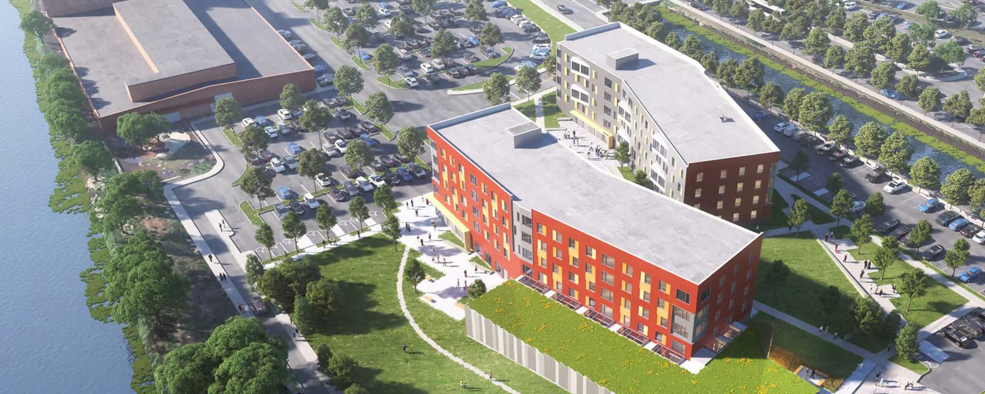 View of exterior of apartments and green lawn at Island Parkside in Lawrence, Massachusetts