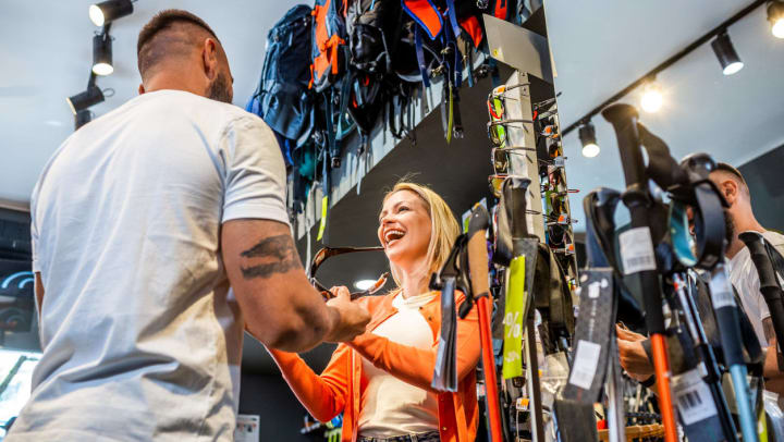 A person talking to an employee about equipment at a sporting goods store | sporting goods stores in Albuquerque