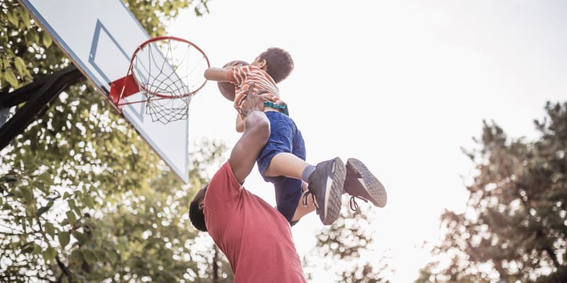 A resident playing with his kid a basket ball near Ben Moreell in Norfolk, Virginia