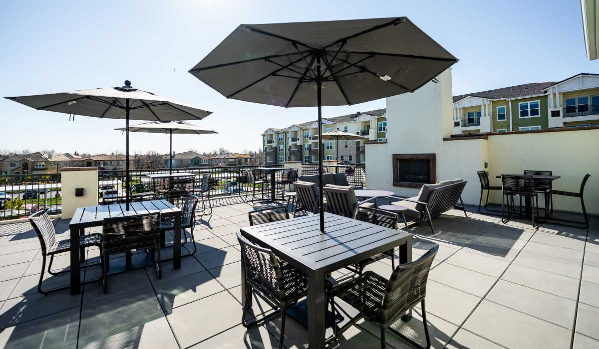 Patio tables outside at Alira Apartments in Sacramento, California