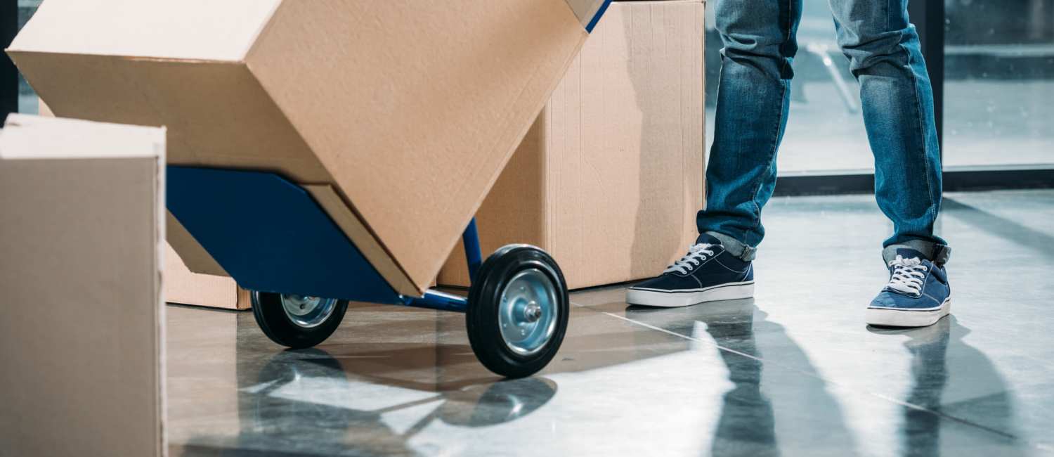 Person wheeling a moving cart with at box at  Smart Self Storage in Van Nuys, California