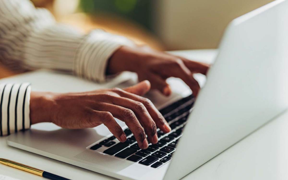 A resident typing on a laptop at Bernwood Trace in Fort Myers, Florida