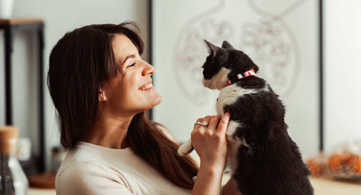 Resident woman playing with her pet cat at Palmhouse Jacksonville in Jacksonville,Florida