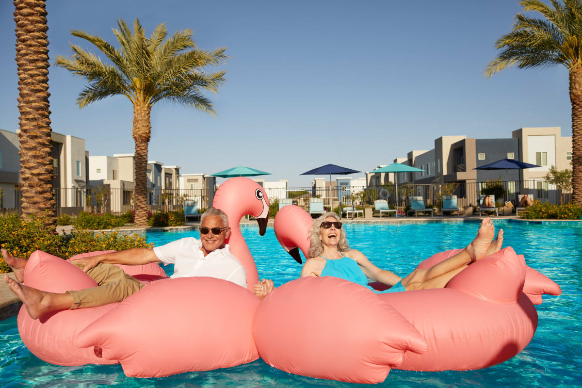 Two residents floating in the pool at BB Living at Union Park in Phoenix, Arizona