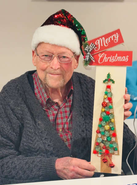 Senior resident posing with crafted holiday decoration