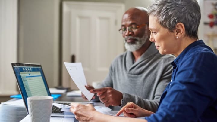 Couple financial planning on lap top