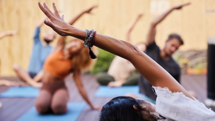 A yoga teacher leading students through poses during a yoga class | yoga studios around South Jordan