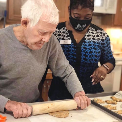 Masked team member and resident at Oxford Glen Memory Care at Sachse in Sachse, Texas