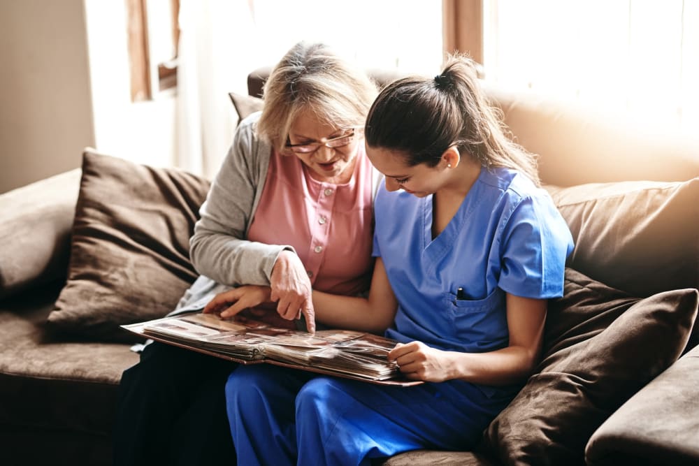 Resident reading with a nurse at Pilot Butte Rehabilitation Center in Bend, Oregon