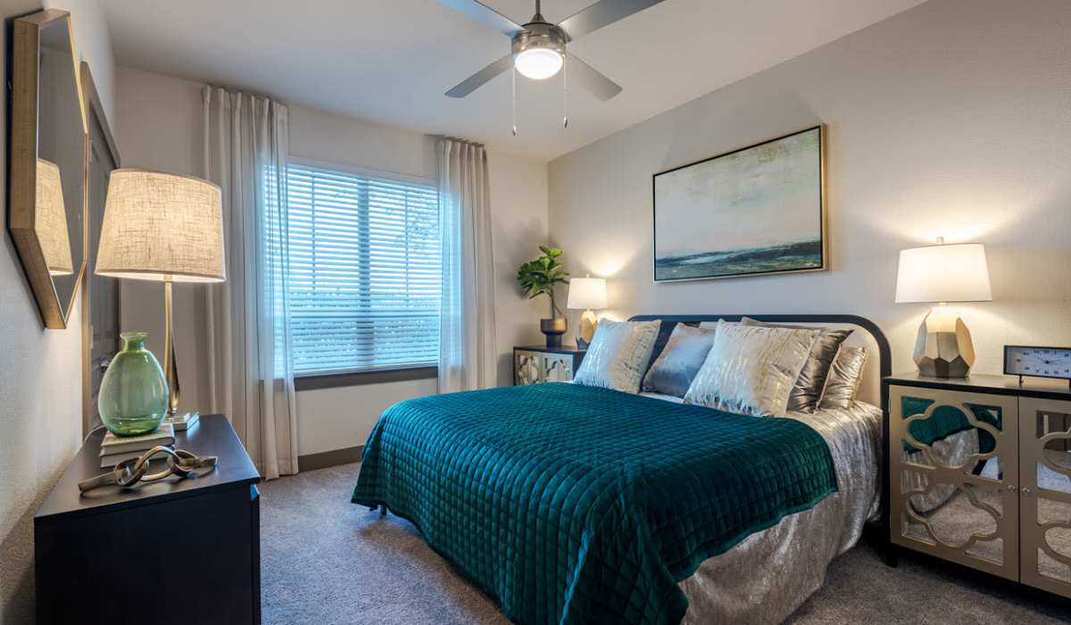 Spacious bedroom with a ceiling fan bed and a window at Dayrise at Centreport in Fort Worth, Texas