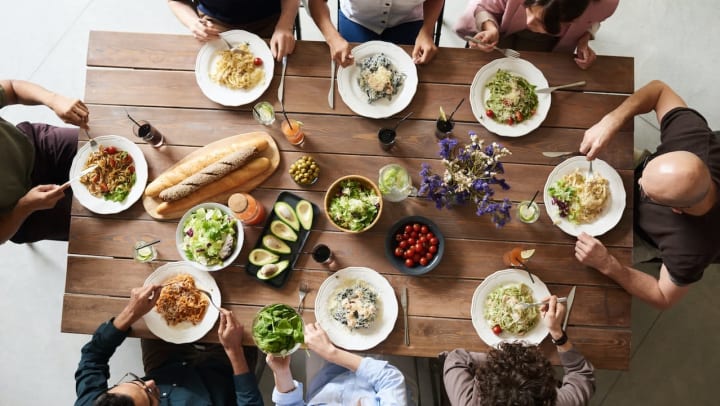 friends gathered around a dinner table | dinner party ideas