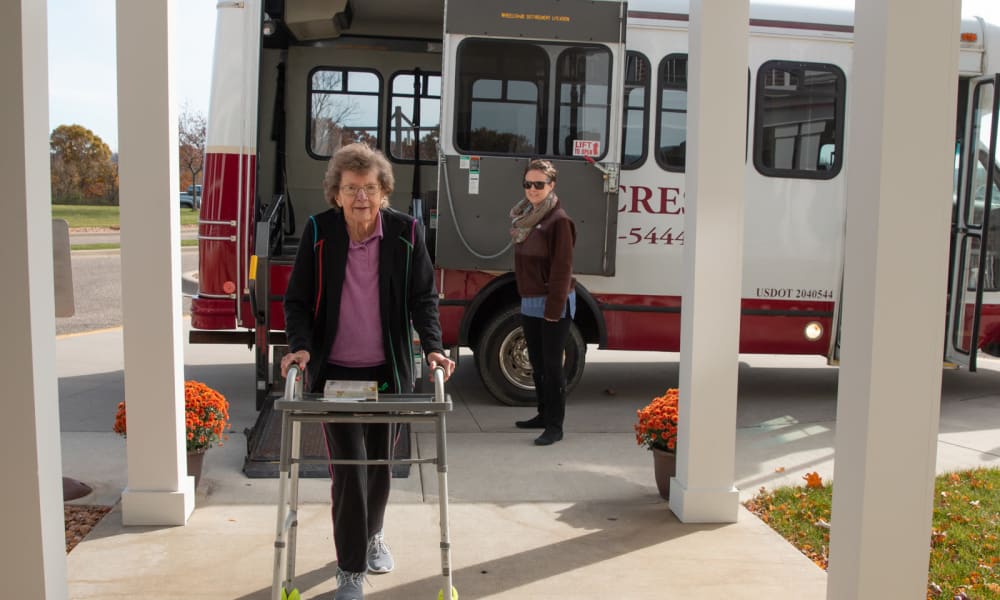 Smiling resident getting off the shuttle at Deer Crest Senior Living in Red Wing, Minnesota