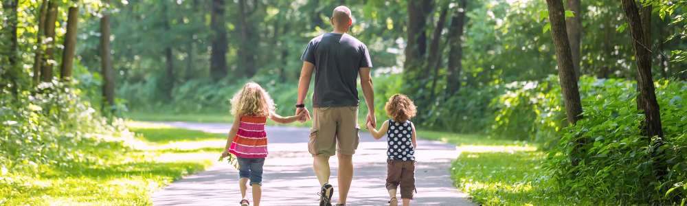 Dad and kids walking in a park near Reedville Meadows in Beaverton, Oregon