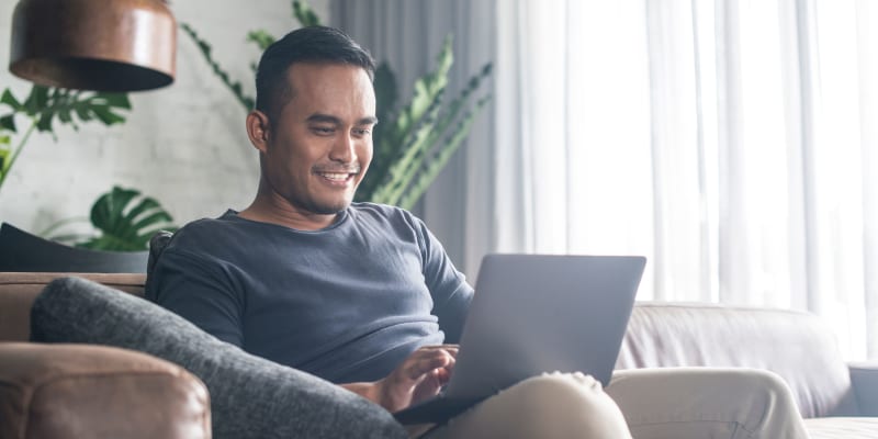 A resident using a laptop in a home at Silver Strand I in Coronado, California