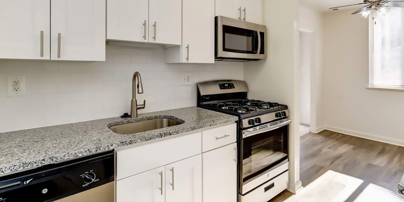 Model kitchen with granite countertops at Hallfield Apartments in Perry Hall, Maryland