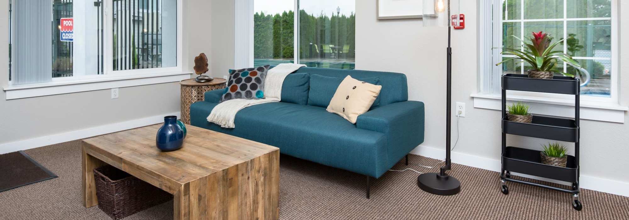 Clubhouse with turquoise color sofa at Chinook Way Apartments in Fairview, Oregon 
