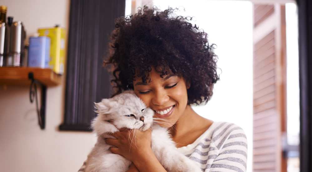 Resident with her pet cat at The Archer Apartments in San Antonio, Texas