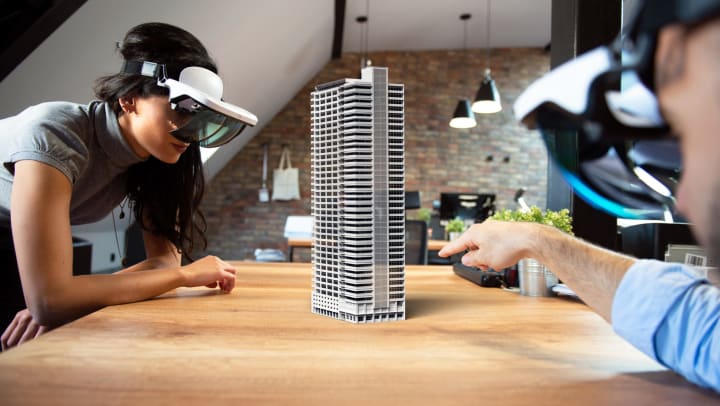 Man and woman completing a 3D puzzle with 3D goggles on at Olympus Steelyard