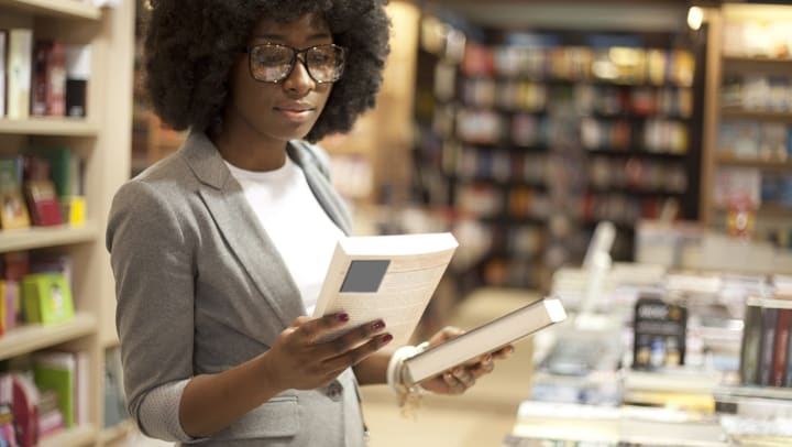 A woman looking at books in a bookstore. 