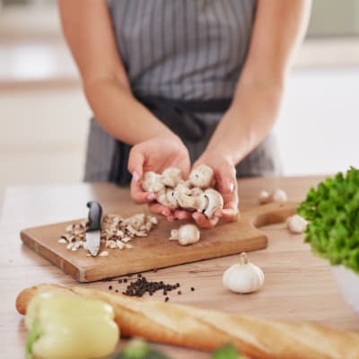 Resident chopping vegetables in the kitchen at Westmont Village in Charlotte, North Carolina