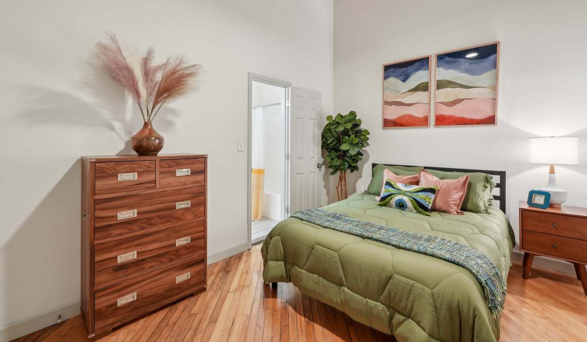 Modern bedroom with lamp and hard wood flooring at South Bank in Richmond, Virginia