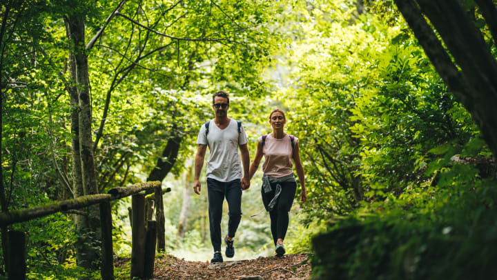man and woman taking a trail walk in parks in Fayetteville