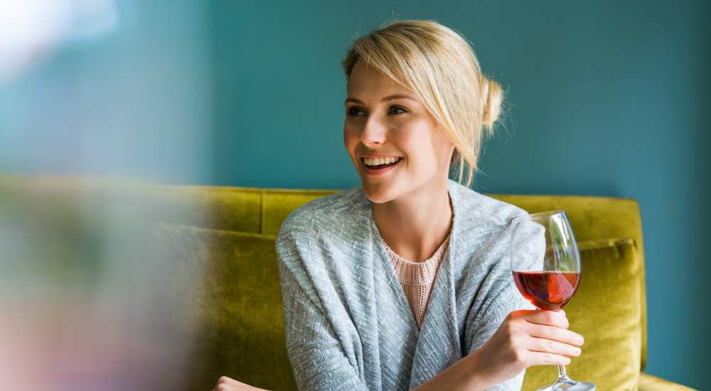 Resident having a glass of wine at home 301 Monroe Place in Hoboken, New Jersey