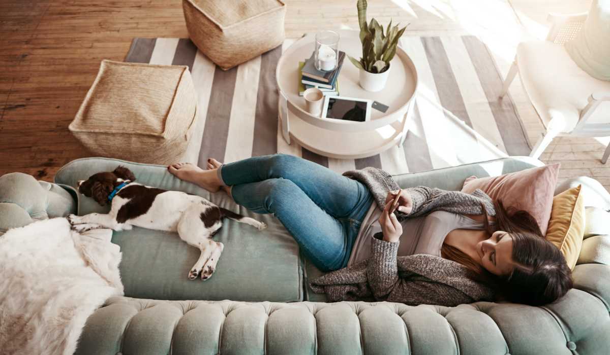 Woman sitting on couch with dog at Brixin Sonora in Fort Wayne, Indiana 