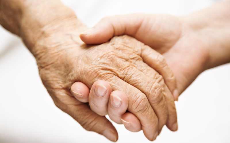 Resident being assisted by a caretaker at Glenncrest at Decatur in Decatur, Georgia