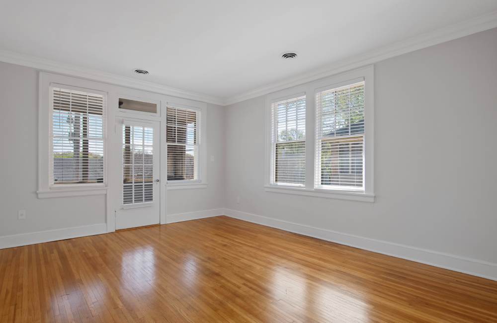 Spacious living room with glass doors for couche and many more at The Linden in Memphis, Tennessee