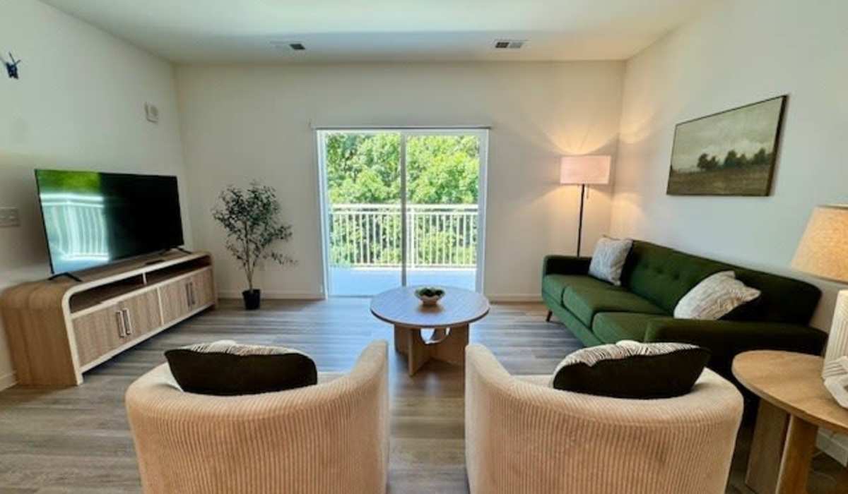 Two armchairs facing a coffee table with access to patio at Pritchard Park Place in Racine, Wisconsin