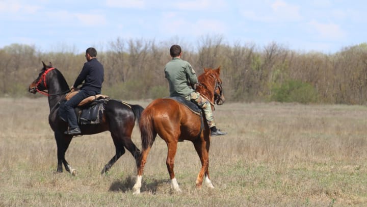 Two residents enjoying a horseback ride near Olympus Willow Park in Willow Park, Texas. 