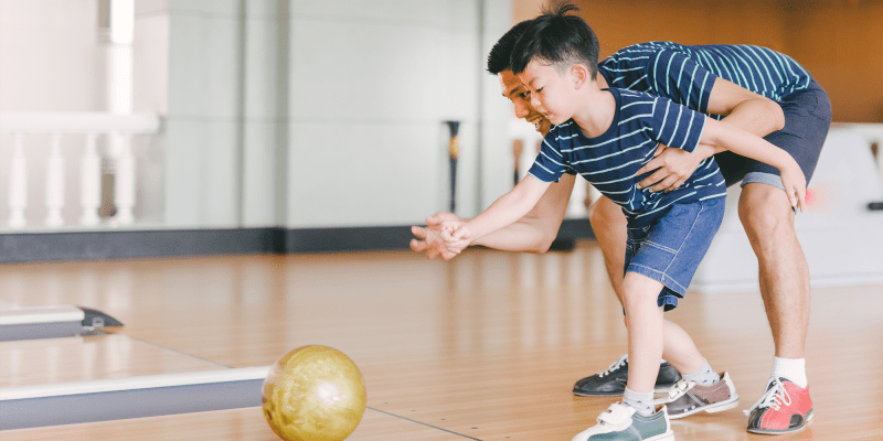 A father and son bowling near Constellation Park in Lemoore, California