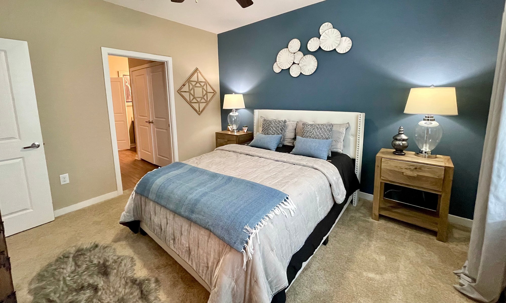 Bedroom in a model apartment at The Abbey at Spring Town Center in Spring, Texas
