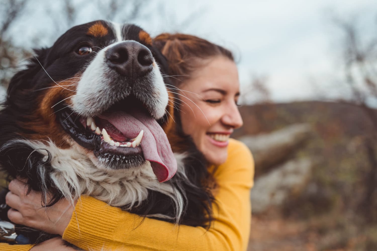 Woman letting her cute dog lick her cheek near Marketplace Apartments in Vancouver, Washington